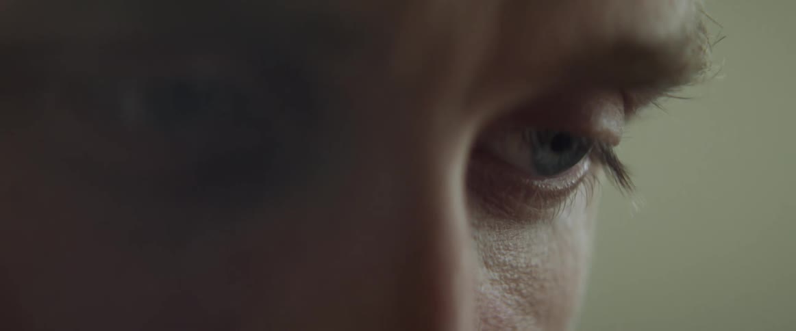 Close up of a mans face looking down