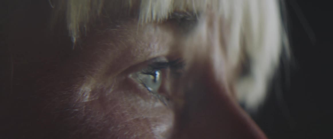 Close up of an elderly womans face crying as the result of a strong emotion