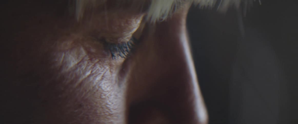 Close up of an elderly womans face crying as the result of a strong emotion