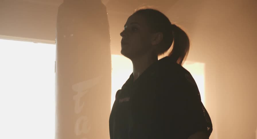 A woman is jumping rope near a window