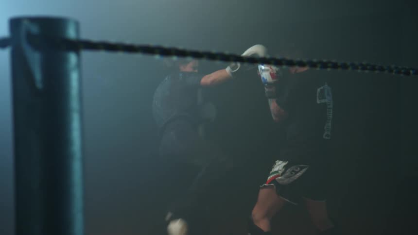 A man and woman kickboxing in a ring