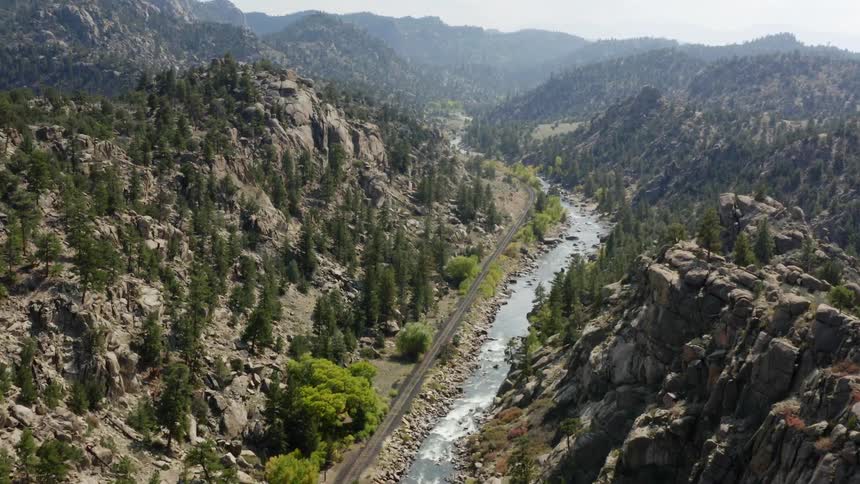 An aerial view of a river flowing in the valley in a mountain range