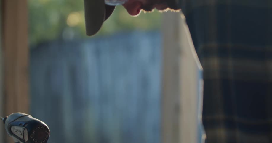 A carpenter marks wood as he builds