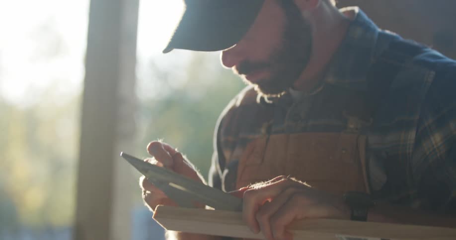 A young man measuring wood