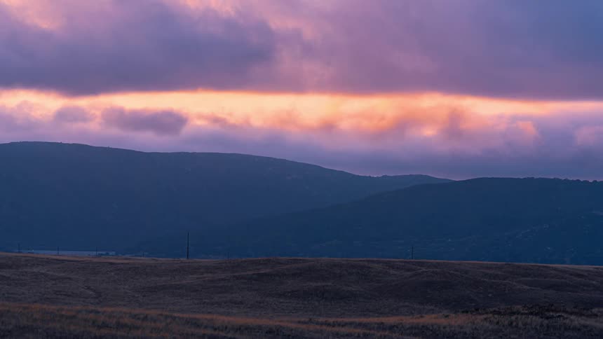 Time lapse of clouds moving over hills