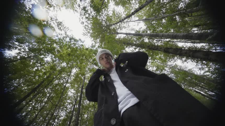 A man is standing in a forest in spring