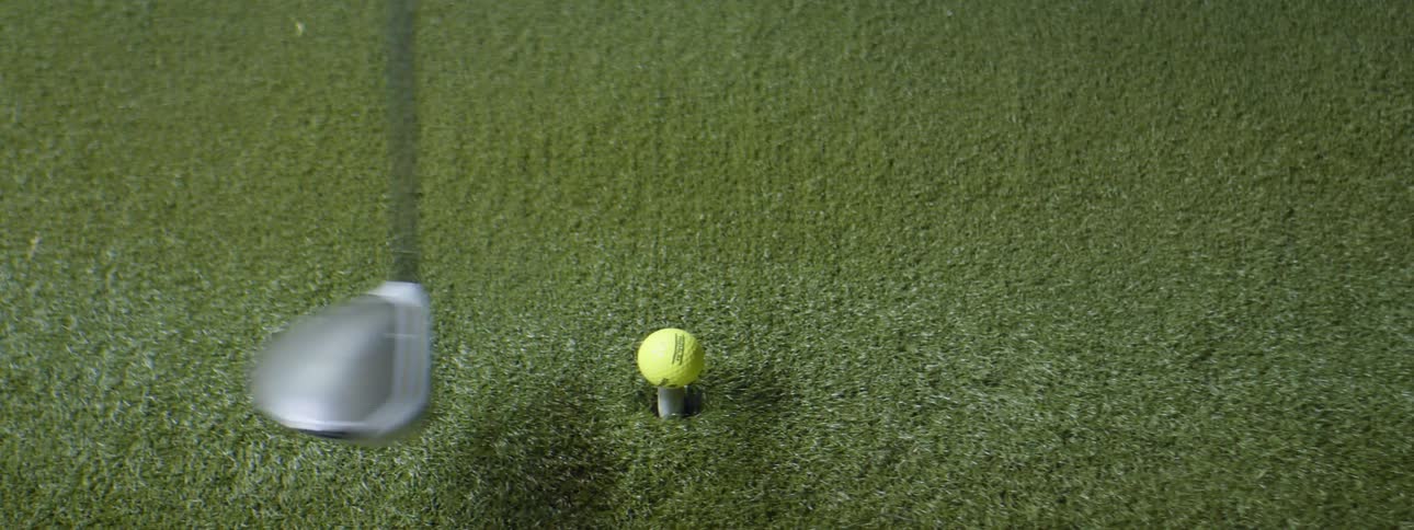 A golfer hitting a golf ball