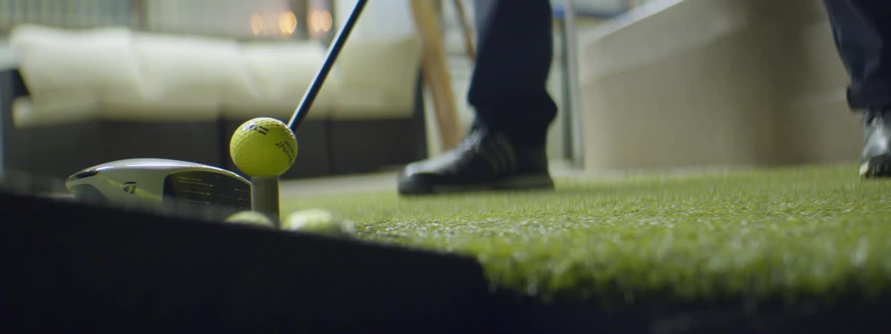 Man practice golf swing in a golf driving range at nigth