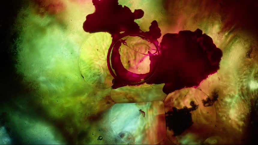 Red liquid spreading slowly to yellow and orange lighted areas
