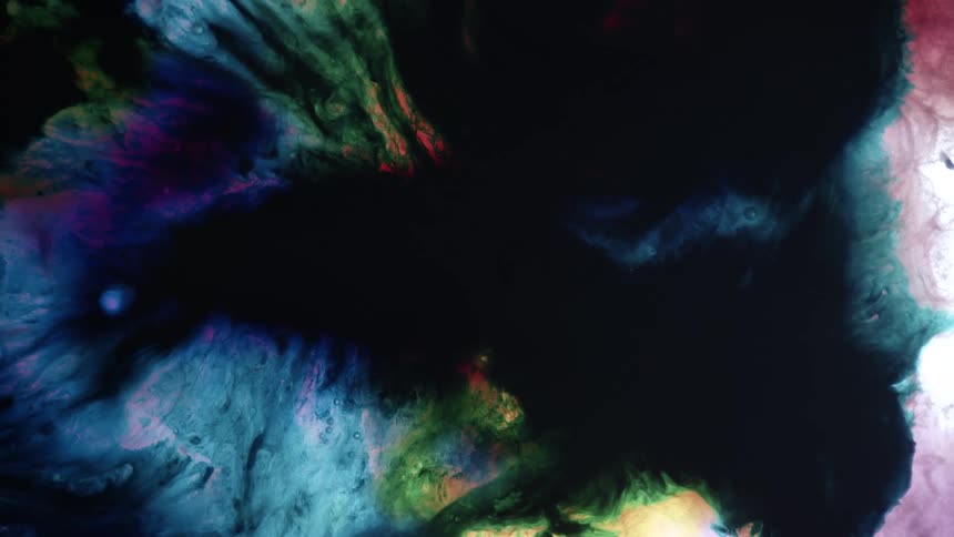 Colorful blue running liquid green ink forming abstract black patterns