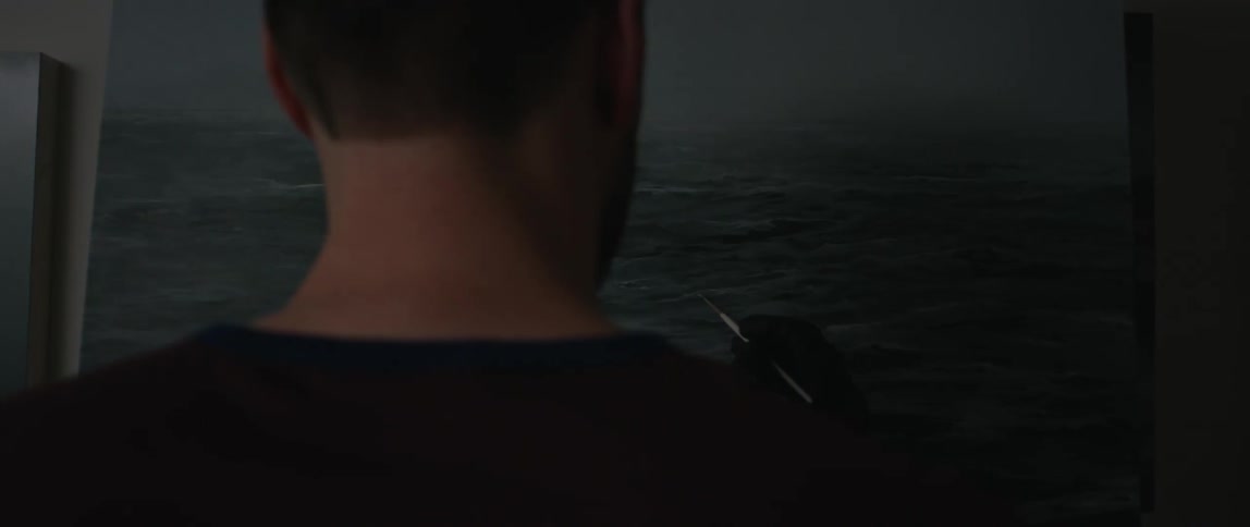 A man is painting an ocean