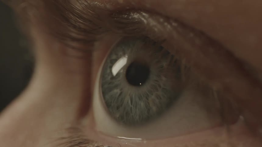 Extreme close up of a womans hazel eye looking at something