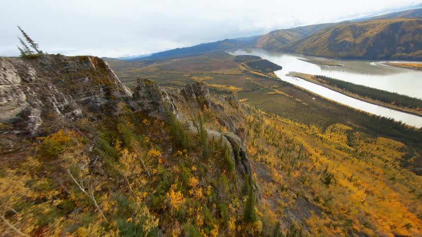 An aerial view of landscape with a river mountains and trees