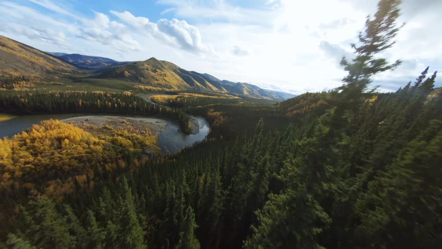 Mountain scape with trees and river below at mid day