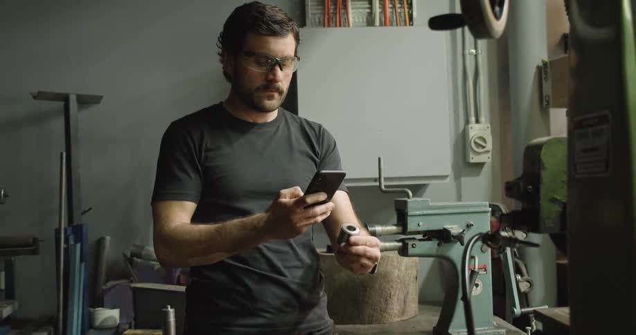 A man photographs an item with his cell phone