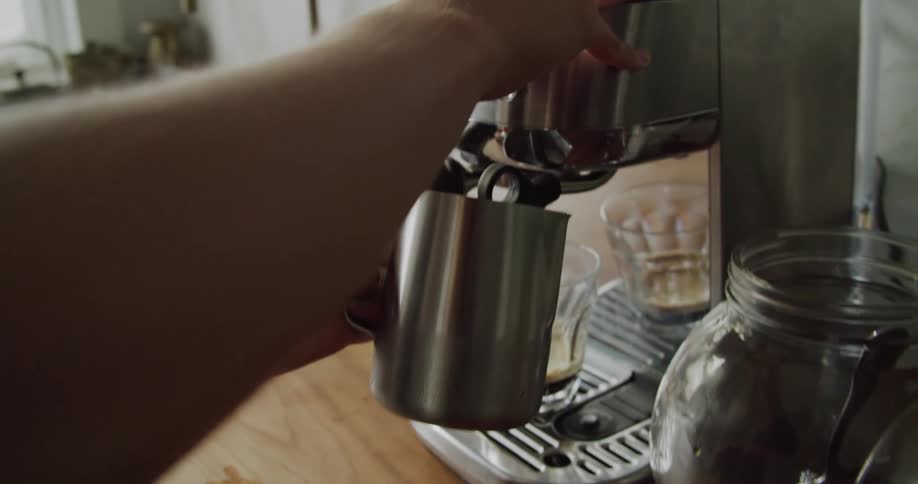 A woman using a coffee machine