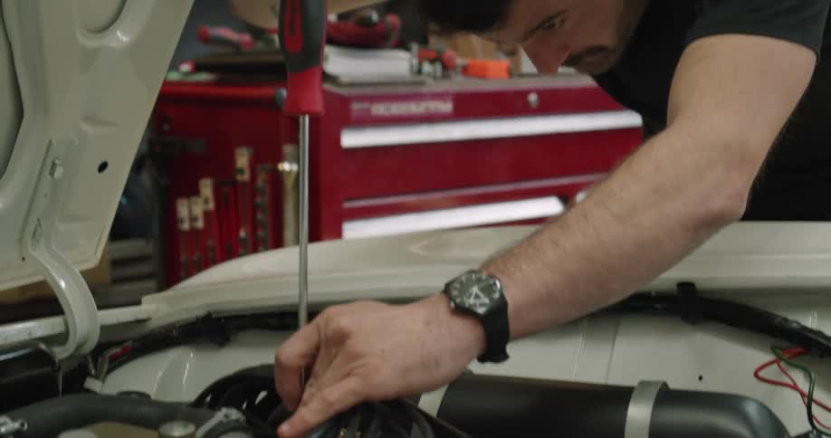 A mechanic is working on a car