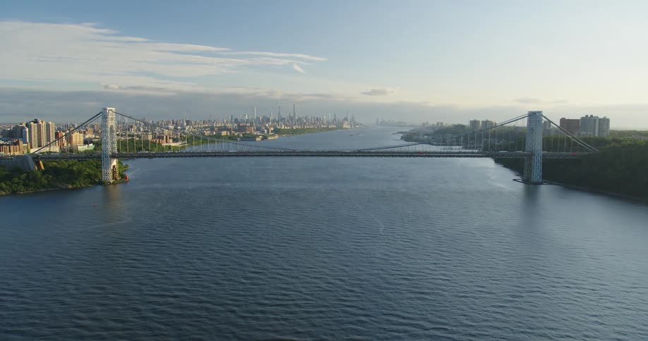 Aerial shot of a bridge over a river in a city