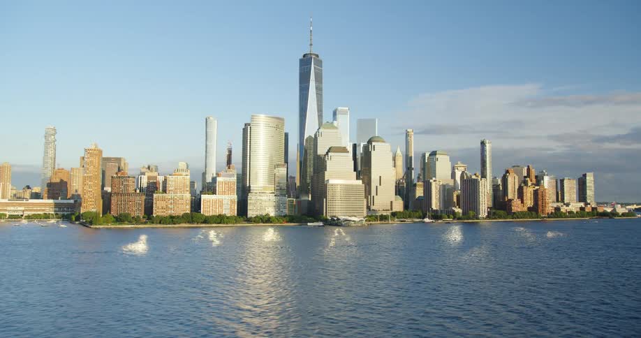 Tower block in a big city with large high rise buildings next to the ocean at daytime