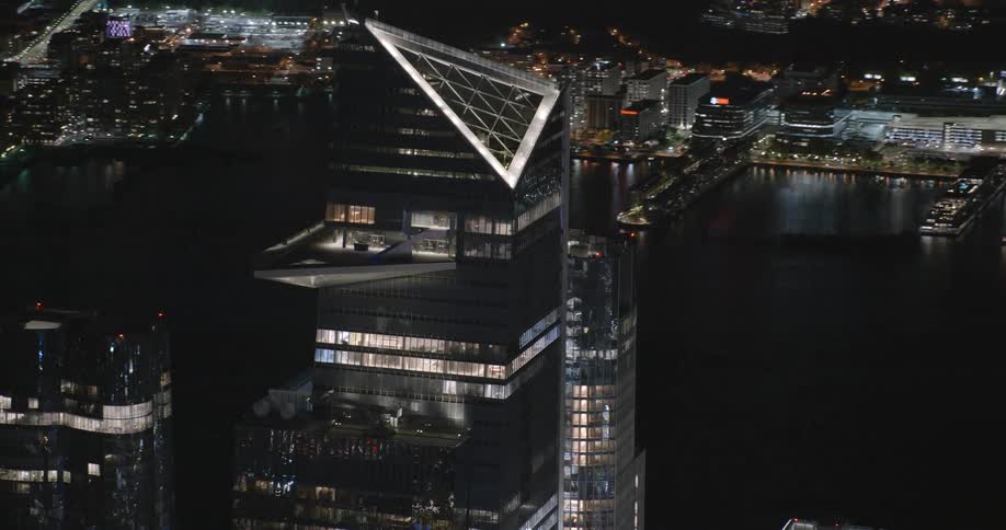 Aerial view of the top of a tall skyscraper in the city at night