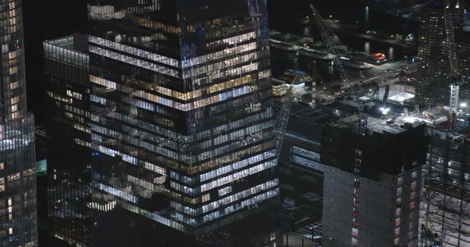 A construction crane on a high rise office building in a downtown area
