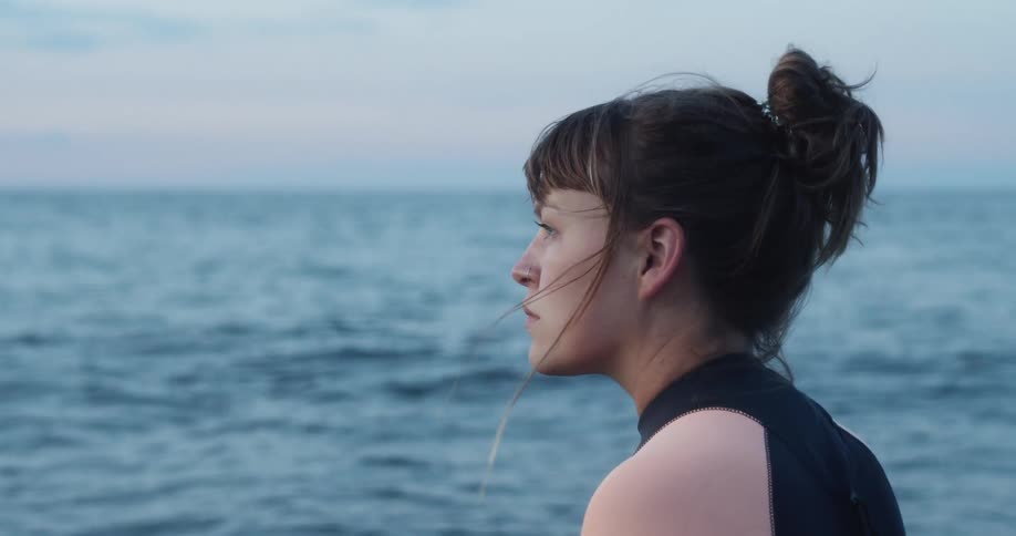 A woman looks out at the ocean