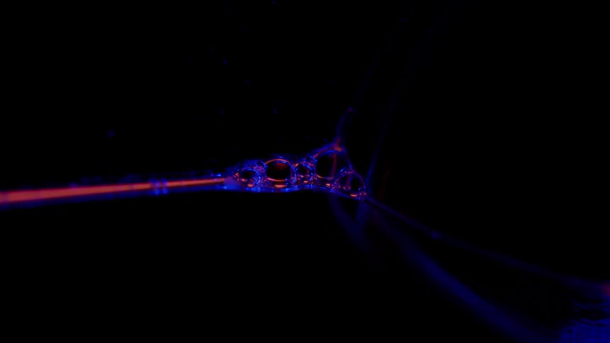 Abstract footage of red and blue neon lights moving and forming patterns