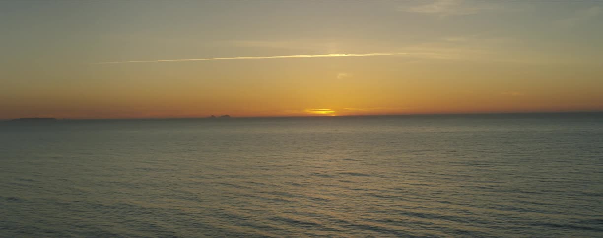 The sun setting over the ocean