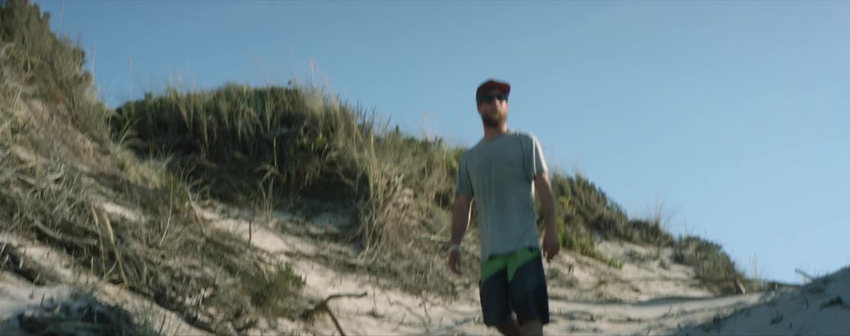 A man walking down a beach