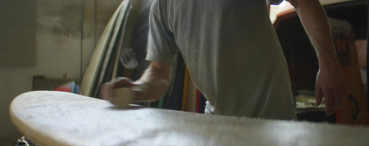 A man polishing a surf board