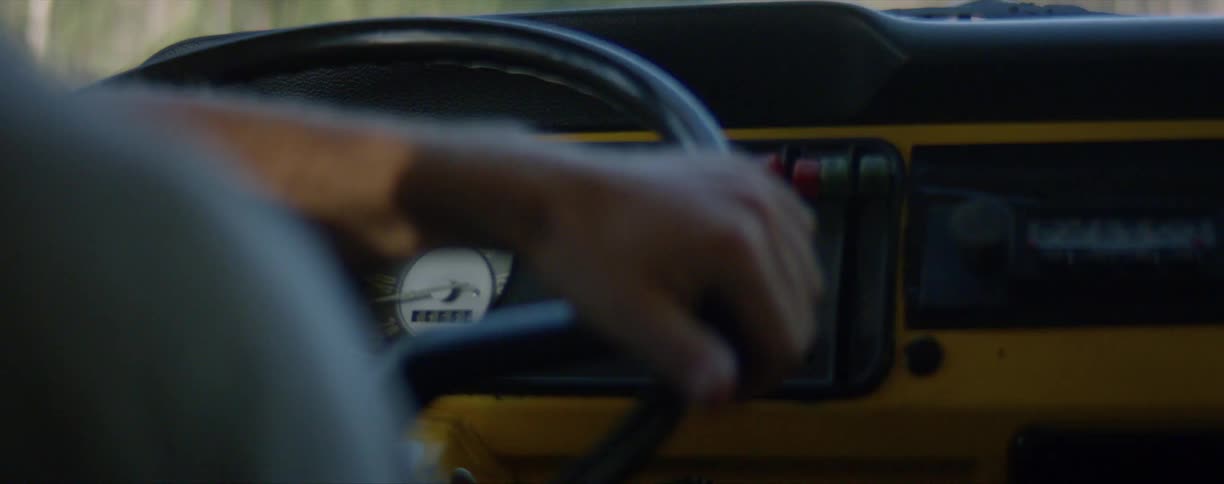 Close up of a mans hand on the wheel of his vehicle as he drives
