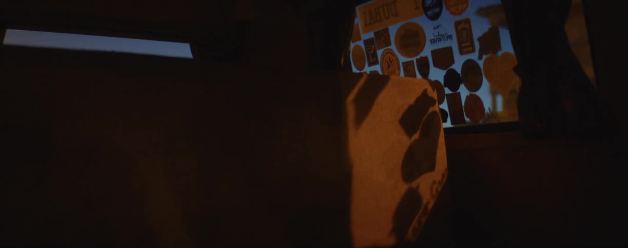 The back seat of a vehicle as it travels through a city in the late evening