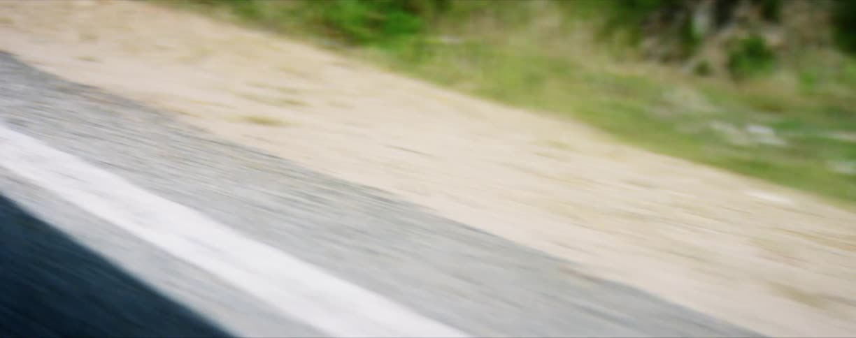 The shadow of a vehicle as it drives on a road