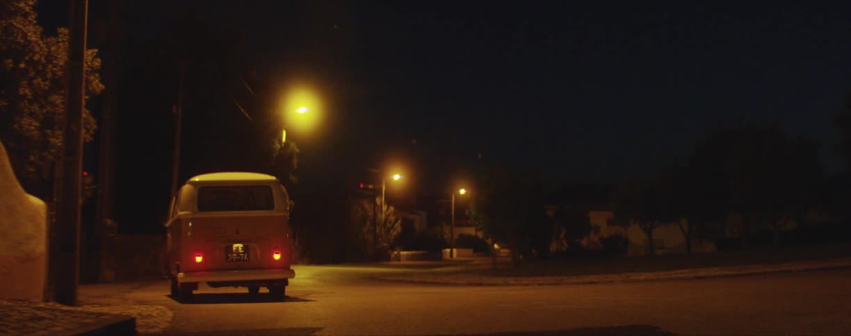 A van stopped on a road at night