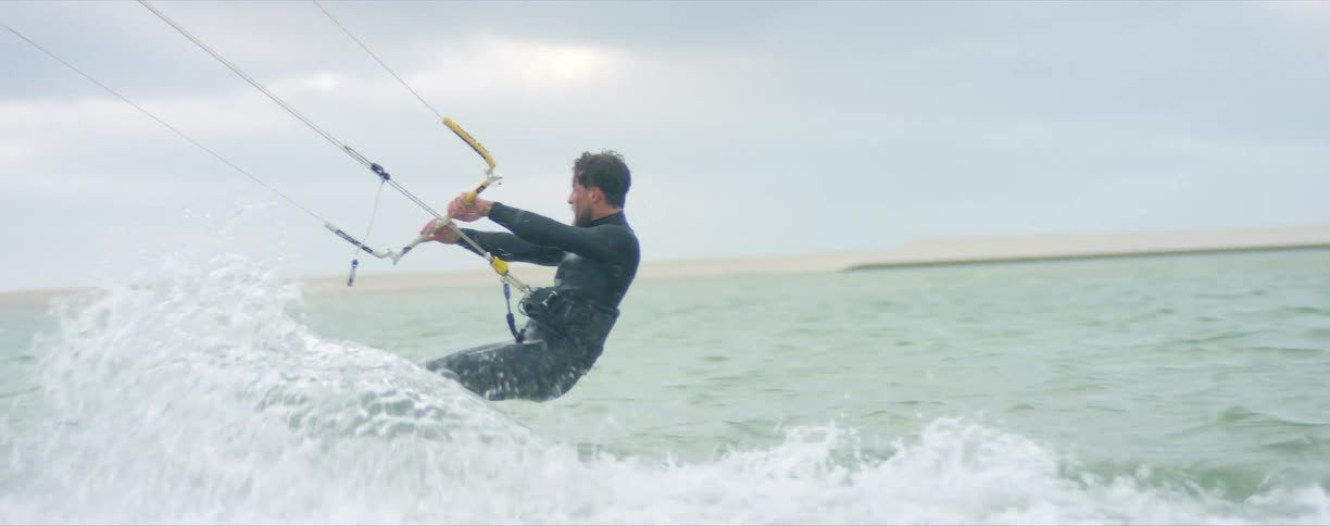 A man parasailing on a coast
