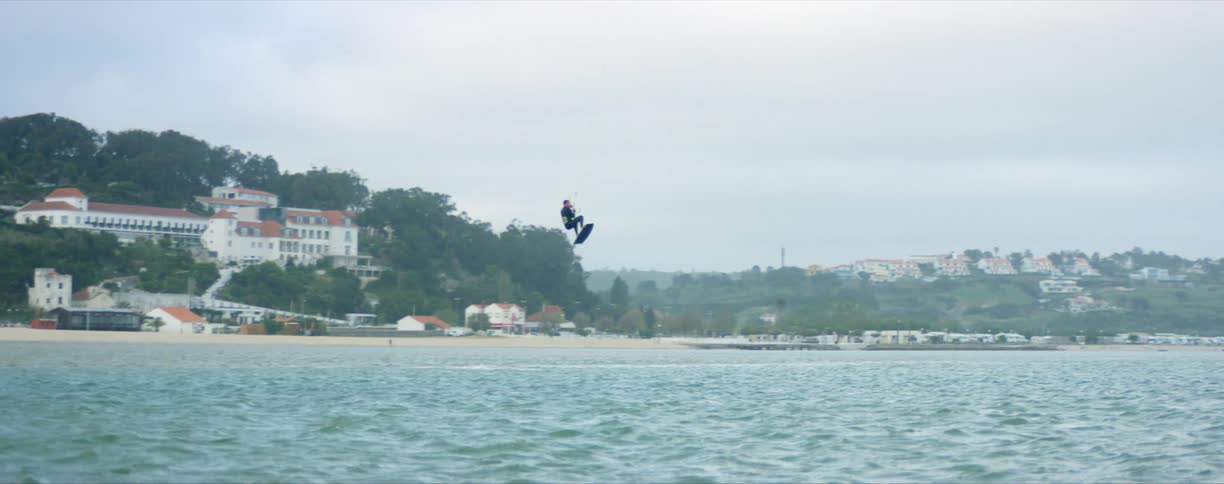 A man parasailing on a coast