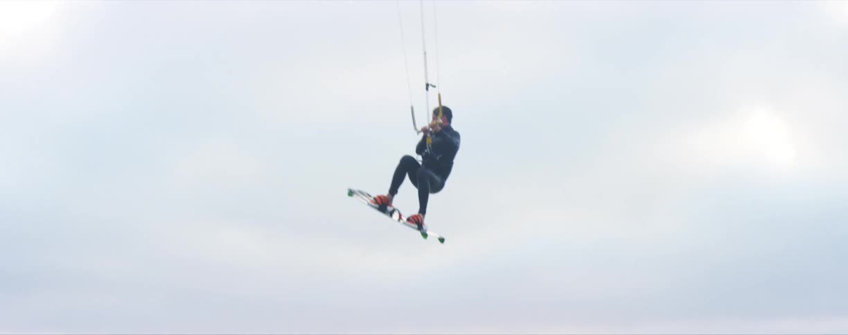 A man parasailing on a coast