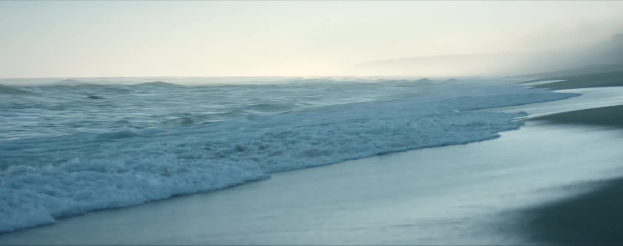 Huge wave rolling in over beach