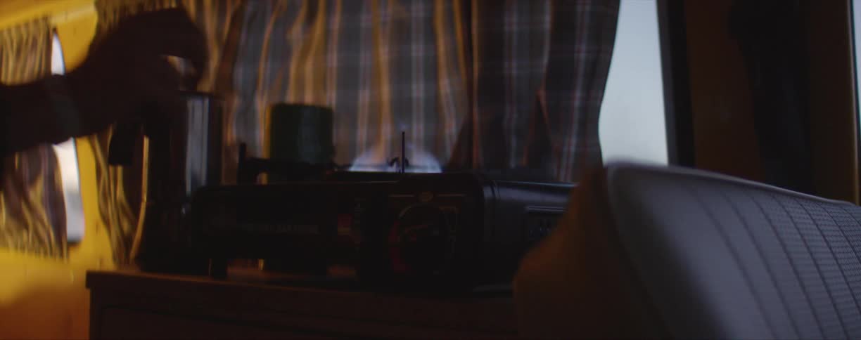 A person turning on a stovetop