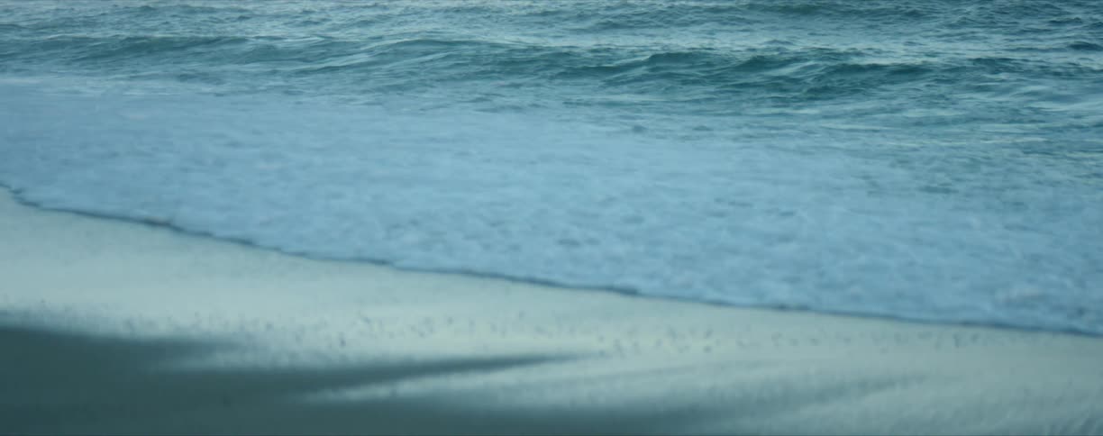 Waves splashing and rolling in on beach coast
