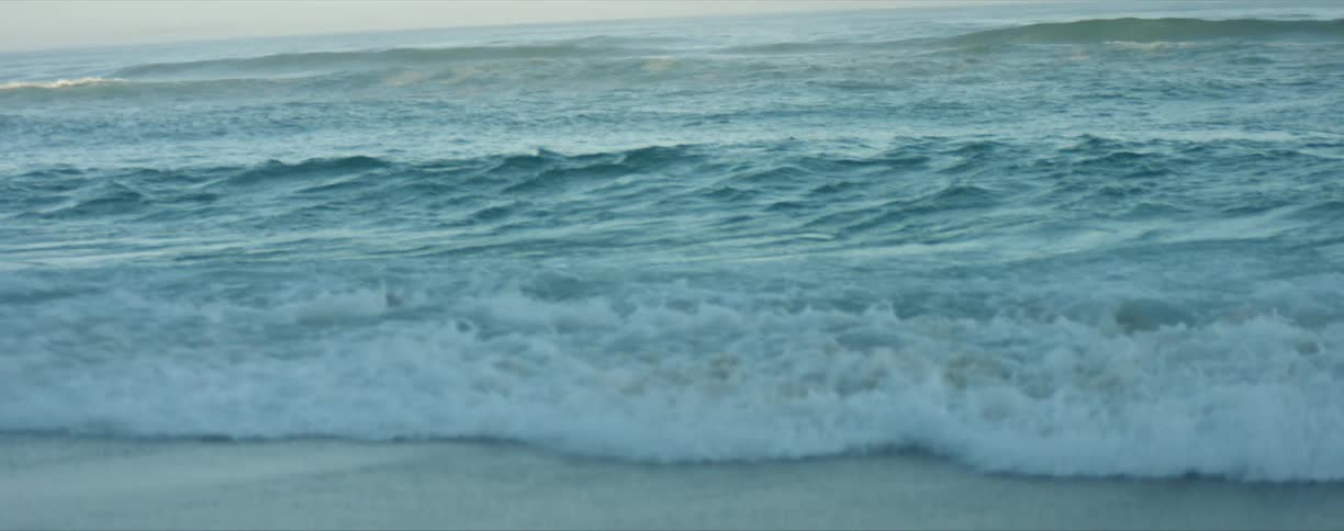 Ocean waves splashing and rolling into shore