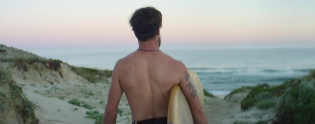 Person walking with surfboard