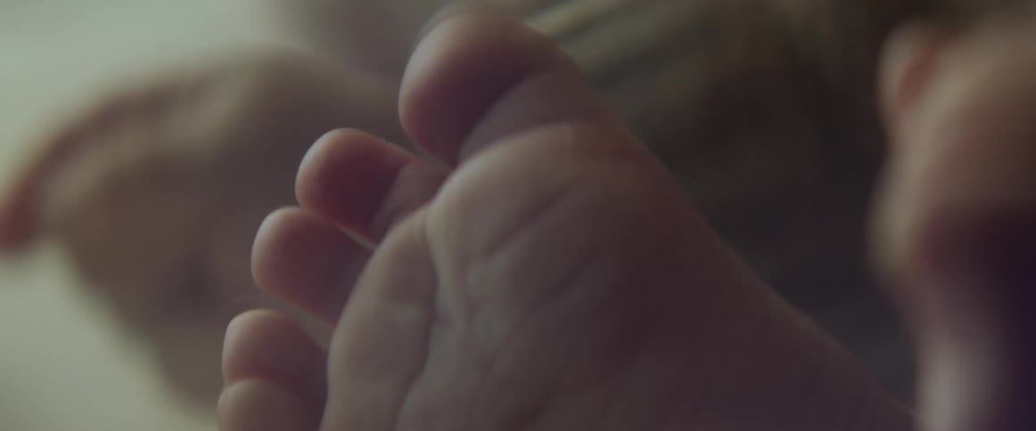 Close up of a babys feet and hands with tiny toes and fingers