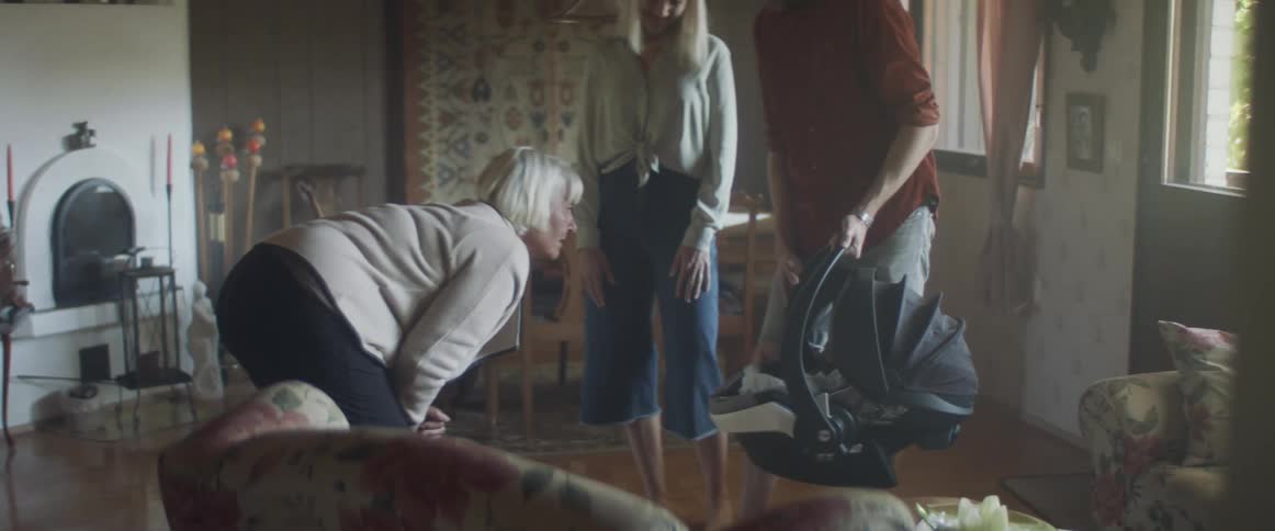 Young couple with their baby visit grandmother at home