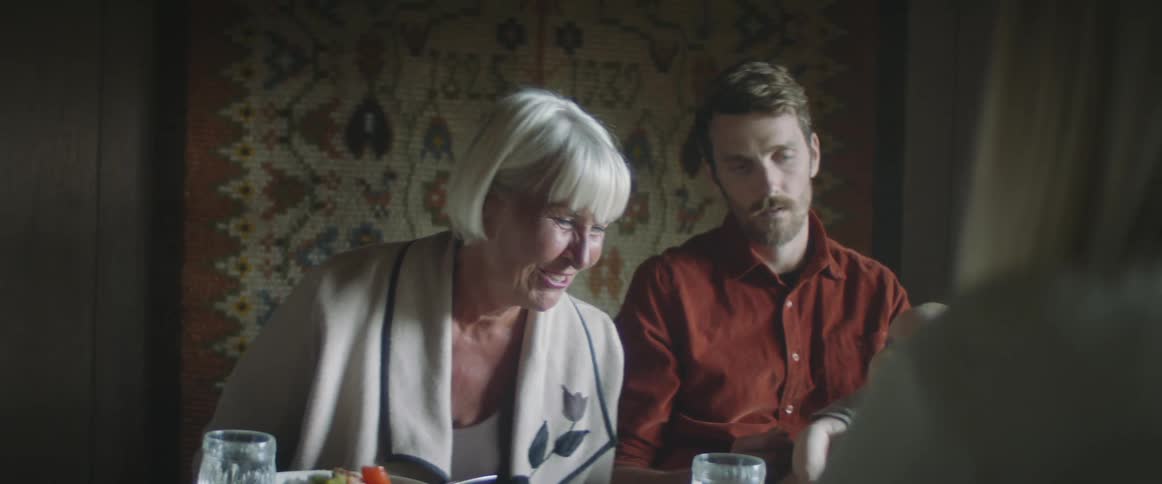 Family having dinner at home in a dimly lit room
