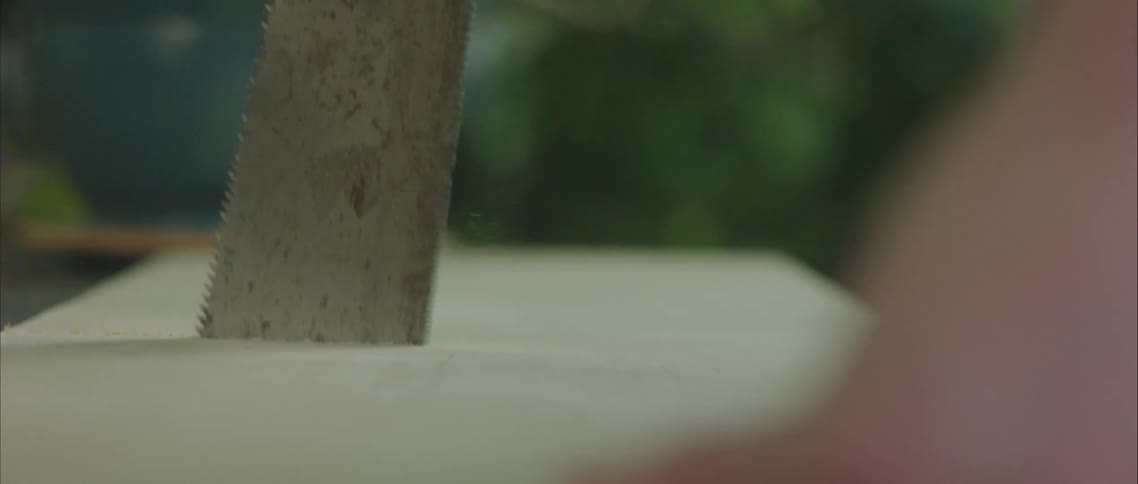 A person cutting wood with a blade