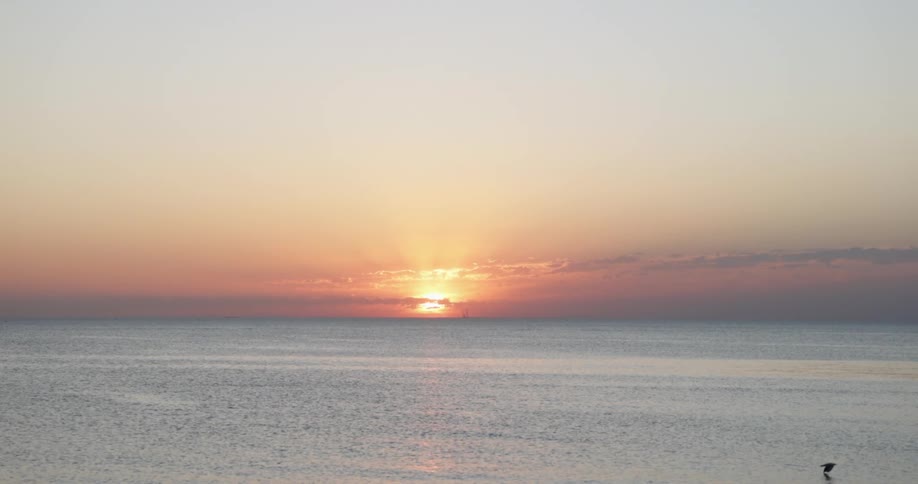 The sun setting over ocean water