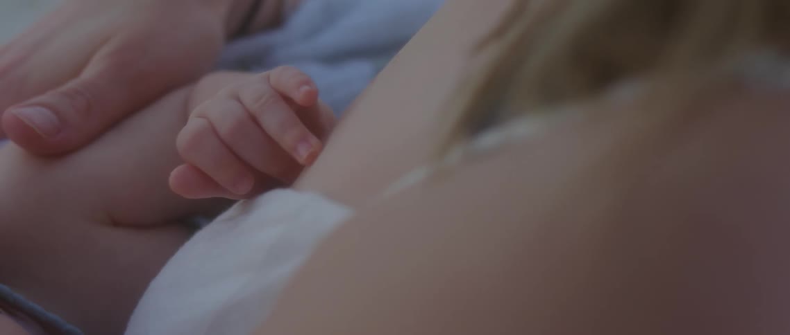 A mother holds her baby close to her