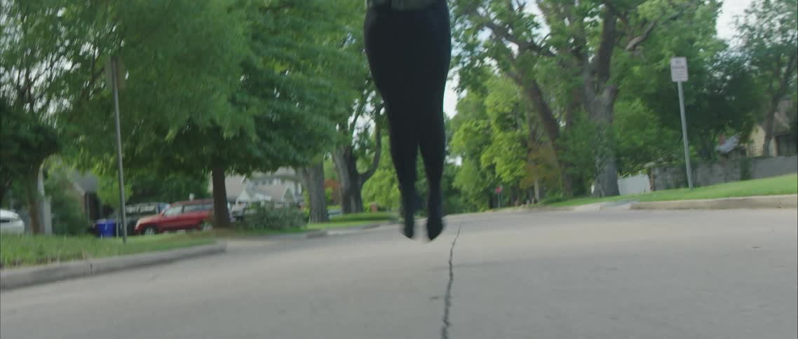 A man dancing in a neighborhood street