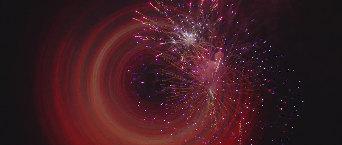 Fireworks being shot into the air with circular lights in various colors